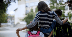 Mother walking children to school